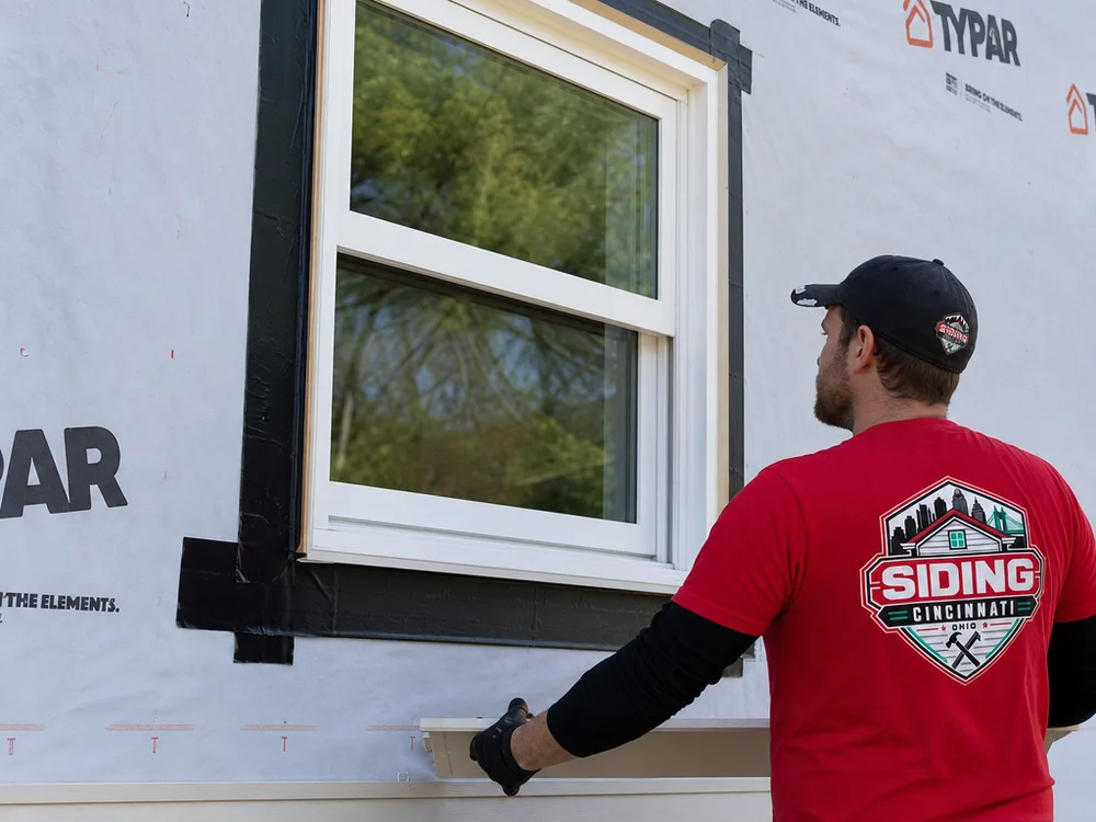 Properly flashed window opening with taped housewrap and trim prepared for siding